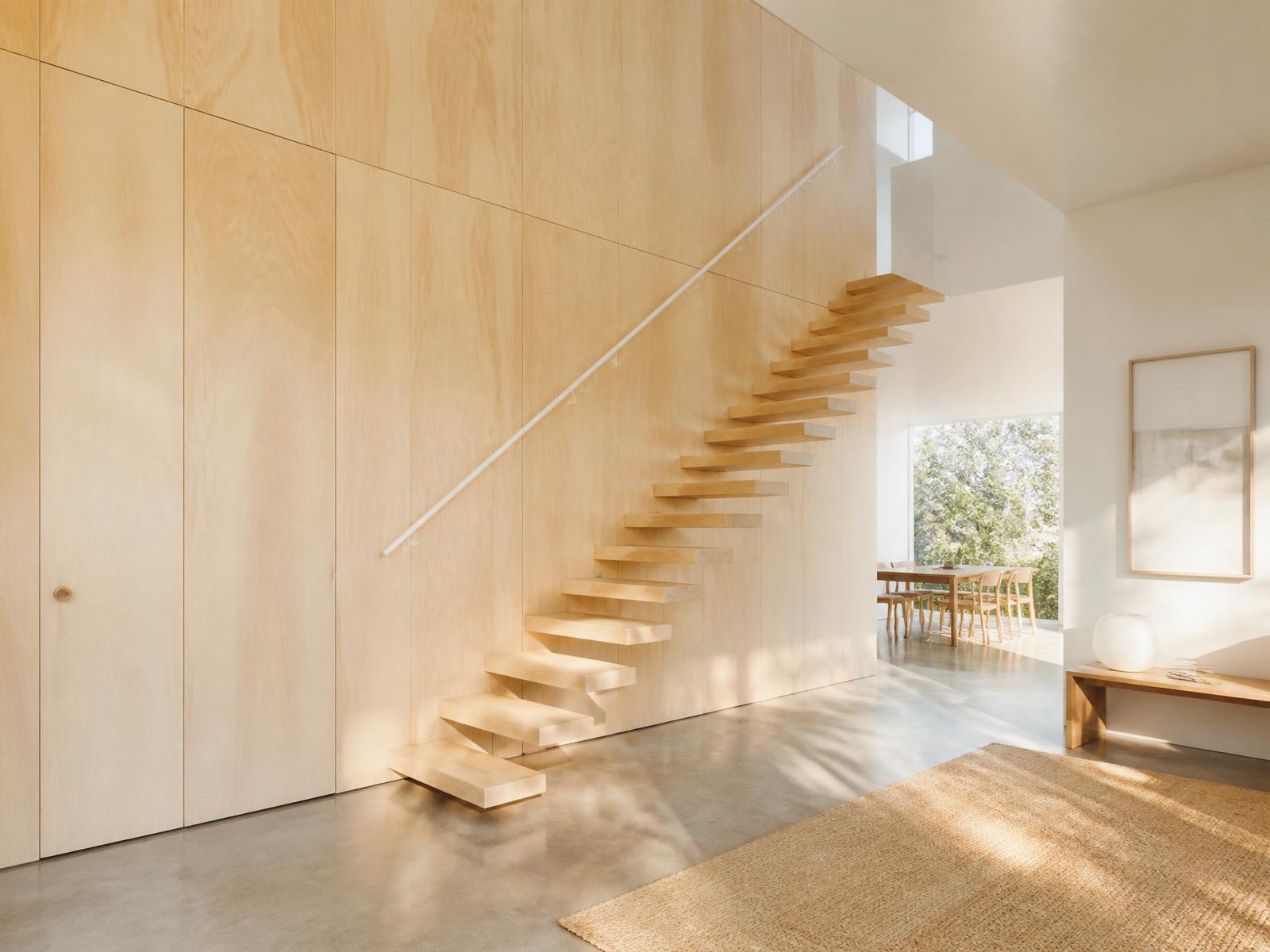 Architectural birch plywood feature wall in a bright Scandinavian interior
